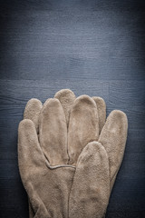 safety working gloves on dark board