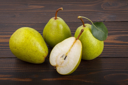 Three and half pears on a wooden background
