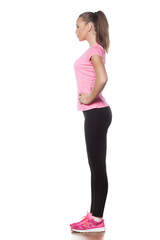 Side view of a beautiful young athlete on a white background