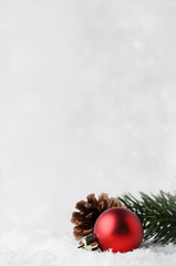 Christmas Background with Red Bauble and Foliage on Snow