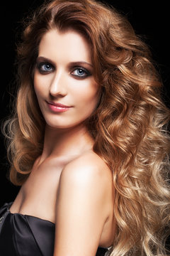 Portrait of young beautiful woman with curly shaggy hair style