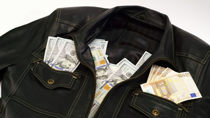 Leather jacket with the dollar and euro banknotes in their pockets 