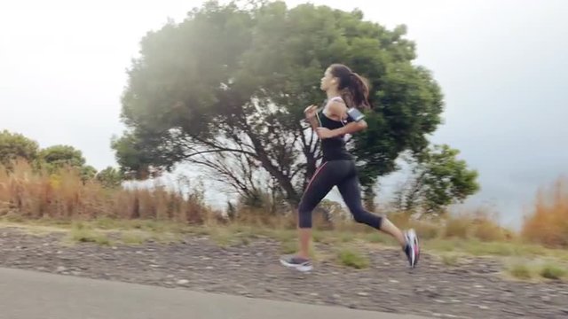 woman running on road close up shoes steadicam shot