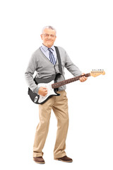 Confident senior playing on an electric guitar