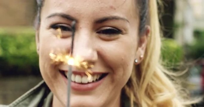 woman holding sparkler celebrating independence day