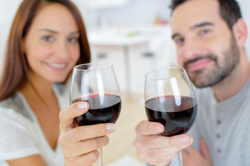 Couple enjoying a glass of wine at home