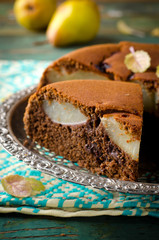piece of homemade chocolate cake with pears and chocolate drops