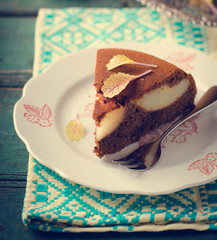 piece of homemade chocolate cake with pears and chocolate drops