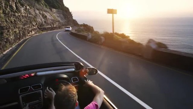 Couple driving convertible car cabriolet cape town south africa steadicam shot