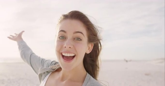 beautiful woman taking selfie using phone on beach at sunset smiling and spinning enjoying nature and lifestyle on vacation