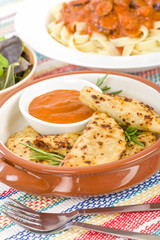Pierogi - Baked dumplings filled with meat and served with a spicy sour cream based dip.
