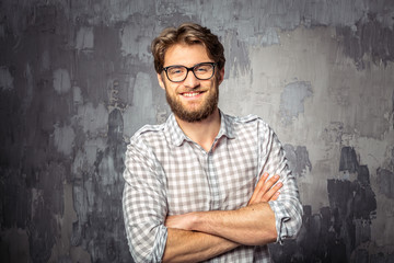 Young handsome man standing with crossed arms