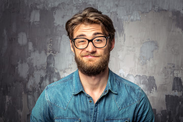 Bearded man with an expression of discontent on his face