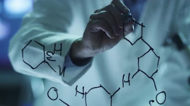 Scientist is Drawing Organic Chemical Formulas on Glass