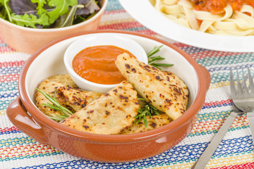 Pierogi - Baked dumplings filled with meat and served with a spicy sour cream based dip.
