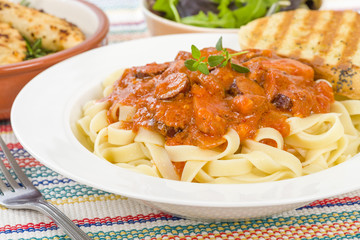 Szekely Gulyas - Hungarian goulash with pork sausage and sour cream on top of pasta and served with a slice of crusty bread.
