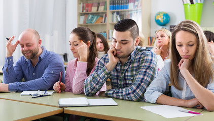 Bored students sitting at lesson