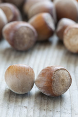 Hazelnuts on old wooden background