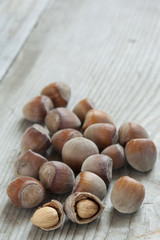 Hazelnuts on old wooden background