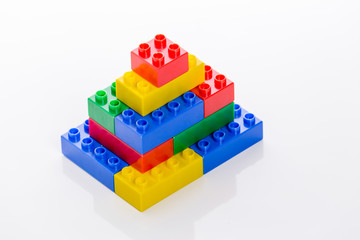 Colorful plastic bricks forming house