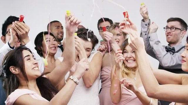 Bridal party shooting poppers slow motion wedding photo booth series