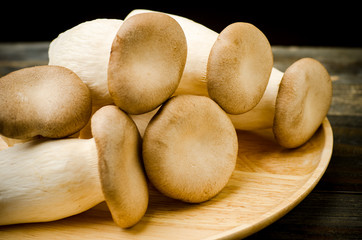 Fresh mushroom on wooden plate