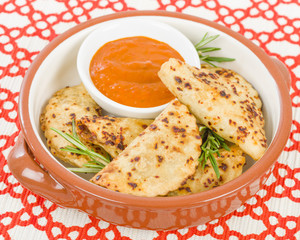 Pierogi - Baked dumplings filled with meat and served with a spicy sour cream based dip.
