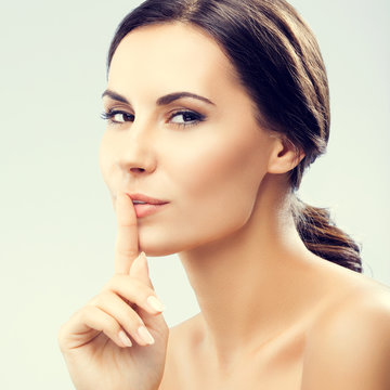 Woman keeping finger on her lips
