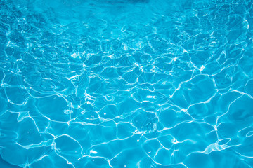 Fototapeta na wymiar Blue water rippled background in swimming pool