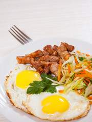 fried egg, meat and vegetable salad