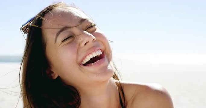 Smiling brunette young woman on beach