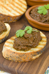 Higados de Pollo - Chicken livers with chorizo & spring onions finished with a dark Cajun tomato sauce on top of crusty bread.
