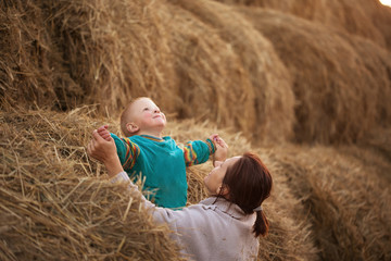 child playing in the straw