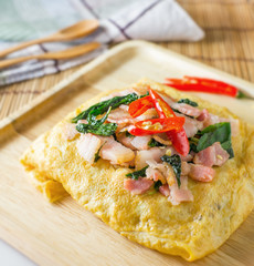stir fried bacon and basil with fried egg