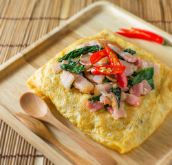 stir fried bacon and basil with fried egg