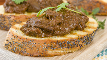 Higados de Pollo - Chicken livers with chorizo & spring onions finished with a dark Cajun tomato sauce on top of crusty bread.
