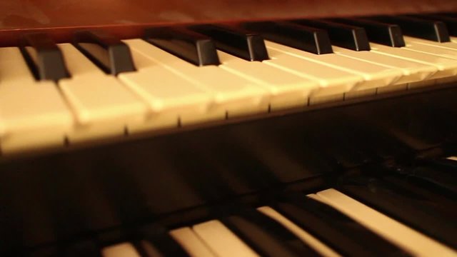 CURRENT SHOT (one of a series): 60fps native slow mo (can also easily be changed to normal speed) dolly move oblique lateral along organ keyboard