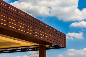 Roof of a new wooden house with a blue sky in the background