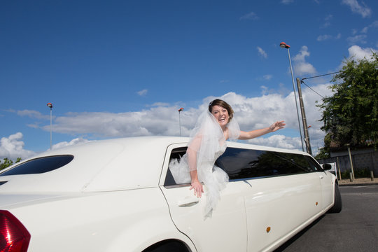 Luxury limo limousine with a bride under blue sky