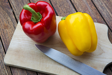 two peppers on wooden table