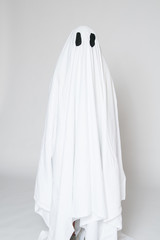 young boy in a homemade ghost costume ready for halloween