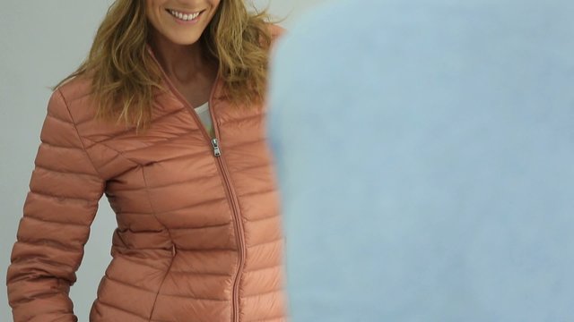 Woman model with down jacket being photographed in studio