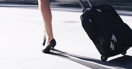 Sexy business woman traveler carry on luggage airport travel concept