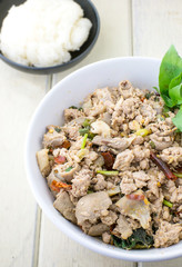 Thai cuisine spicy pork salad on wood table