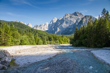 Naklejka na ściany i meble Valley in the Alps with a river and mountains