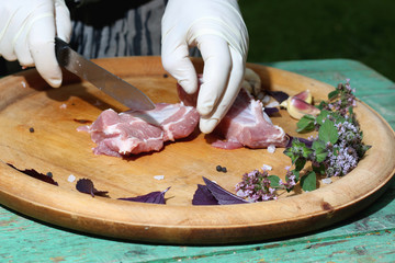 Fresh raw meat on a platter with herbs