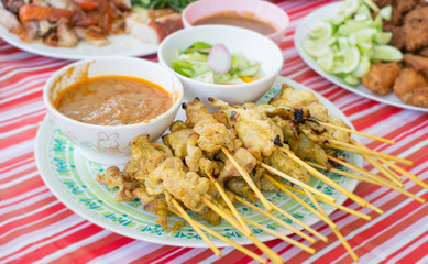Pork satay on red table