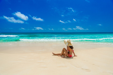 Fototapeta na wymiar Happy girl at Beautiful beach on island Mahé in Seychelles - Anse Intendance 