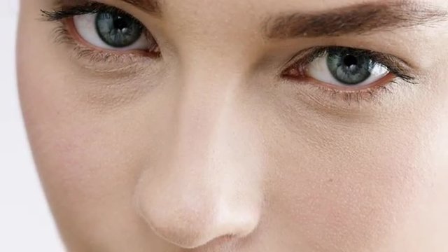 Beautiful woman macro closeup bright blue eyes slow motion skincare concept - Red Epic Dragon