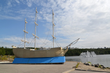 Fototapeta na wymiar Decorative model of the three-mast sailing ship. Murmansk, city